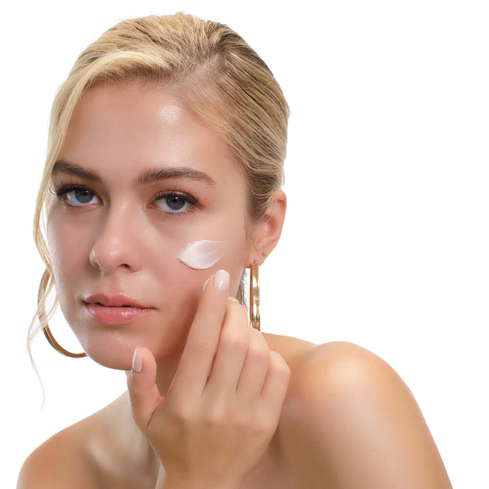 Woman Applying Collagen Cream to Her Cheek